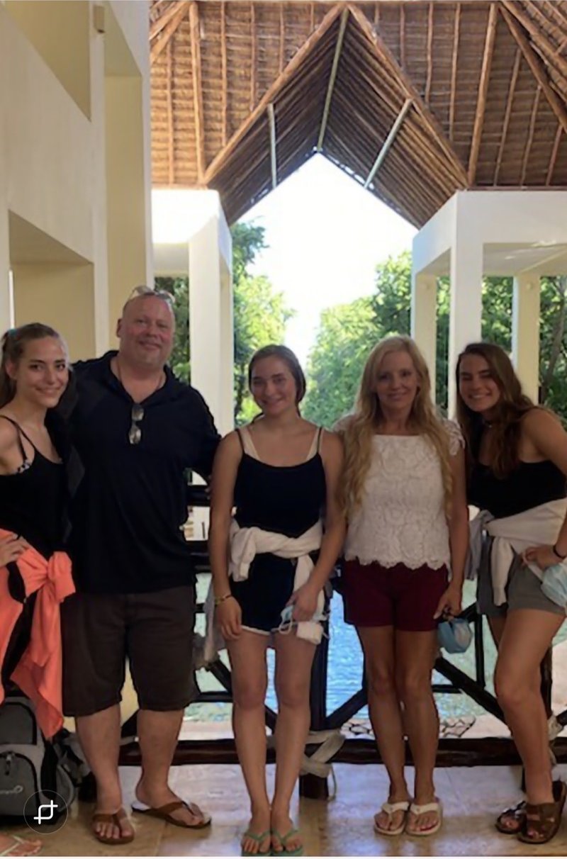 Scott Howell with his wife and daughters at a tropical resort