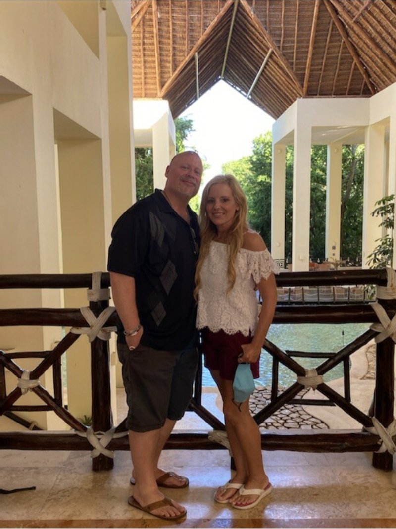 Scott Howell and his wife on a tropical vacation at a resort